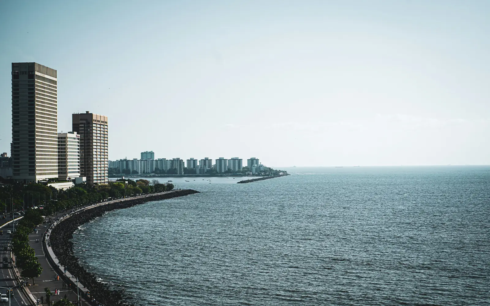 Marine Drive in Mumbai curving along the Arabian Sea, with high-rise buildings at Nariman Point.