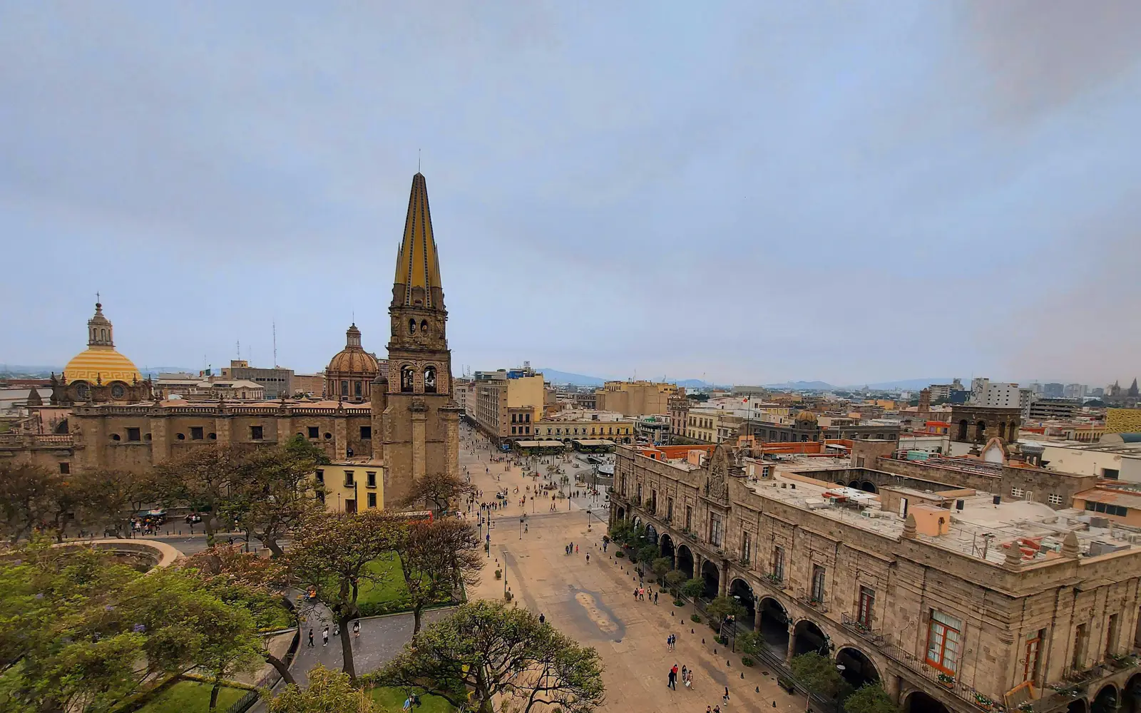 A high view over the historic centre of Guadalajara, Mexico, with the cathedral spires and tree-lined plazas.